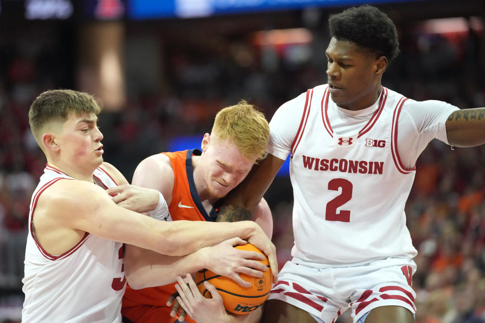 March 2, 2024; Madison, Wisconsin; Wisconsin Badgers guard Connor Essegian (3) and guard AJ Storr (2) try to gain possession of the ball against Illinois Fighting Illini guard Luke Goode (10) during the first half at the Kohl Center. Kayla Wolf-USA TODAY Sports