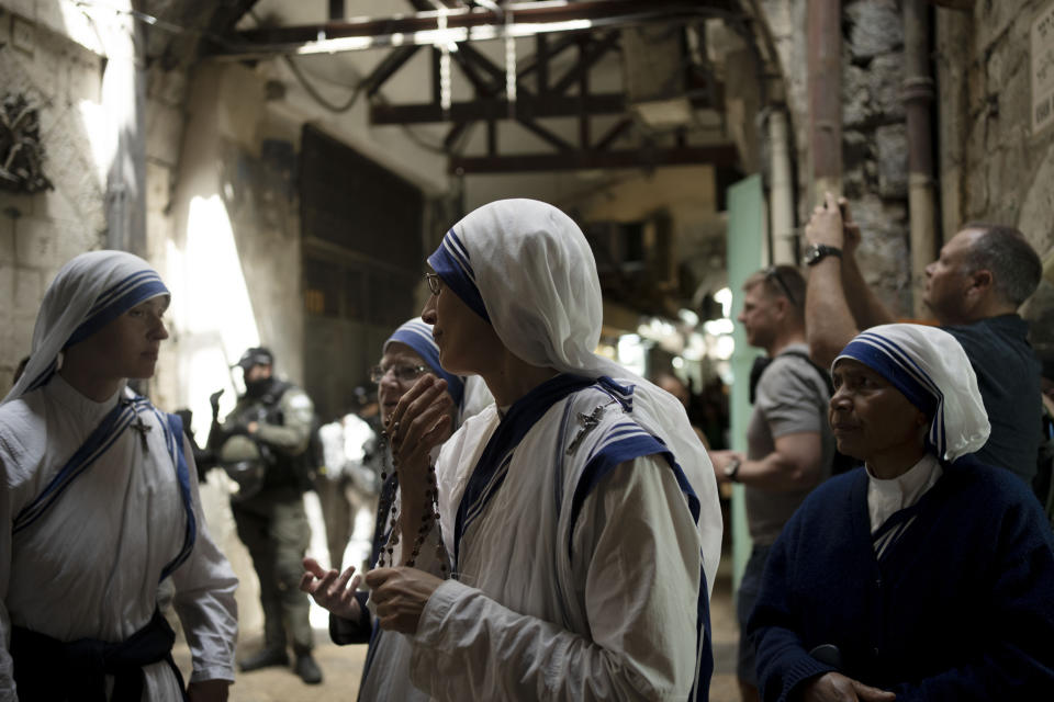 Nuns pause in a procession along the Via Dolorosa, a route that is believed to be the path Jesus walked to his crucifixion, on Good Friday in the Old City of Jerusalem, Friday, April 7, 2023. (AP Photo/Maya Alleruzzo)