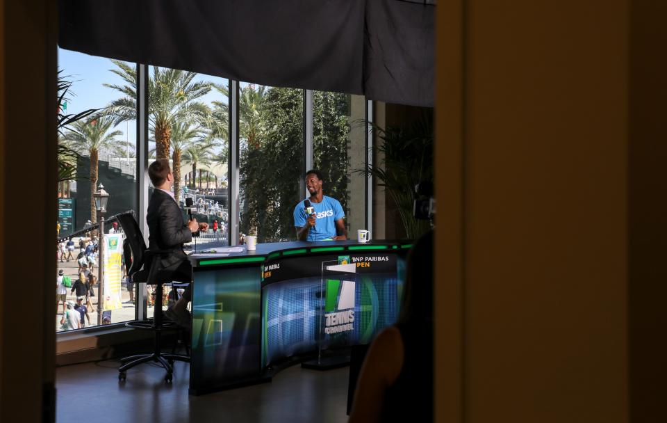 Gael Monfils of France is interviewed by Tennis Channel broadcaster Steve Weissman while they watch his wife, Elina Svitolina of Ukraine, play her match during the BNP Paribas Open, Sunday, Oct. 10, 2021, in Indian Wells, Calif. 