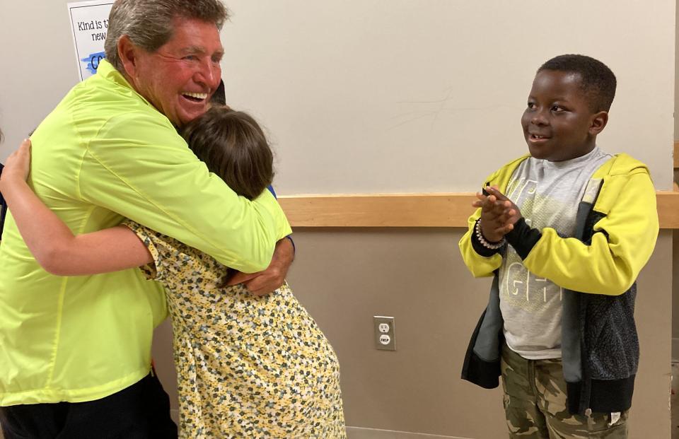 Crossing guard Rick “Rickie" Spearin is greeted with cheers, hugs and fist bumps June 3, 2022 at the Elizabeth Pole Elementary School. Spearin received honorable mention in Crossing Guard of the Year awards announced by MassDOT's Safe Routes to School program.