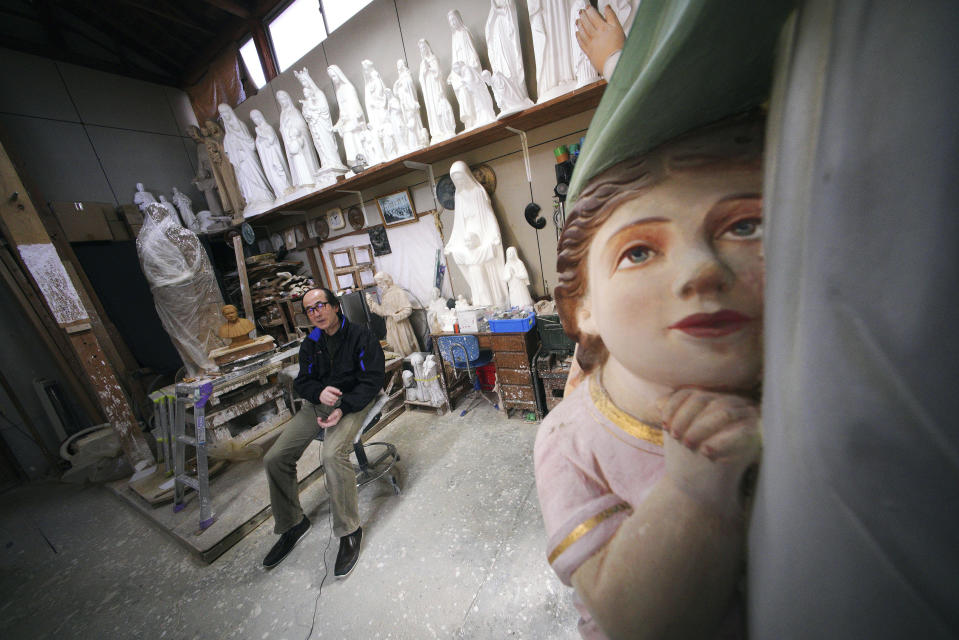 In this Nov. 16, 2019, photo, Mitsuho Nakata, a Catholic statue artist, speaks during an interview at his workshop near the Urakami Cathedral in Nagasaki, southern Japan. Pope Francis will start his first official visit to Japan in Nagasaki, ground zero for the Christian experience in a nation where the Catholic leader once dreamed of living as a missionary. (AP Photo/Eugene Hoshiko)