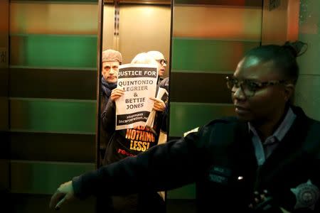 Protesters pack the elevator heading to the floor of the Mayor's office at City Hall in Chicago, Illinois, United States, December 31, 2015. REUTERS/Alex Wroblewski