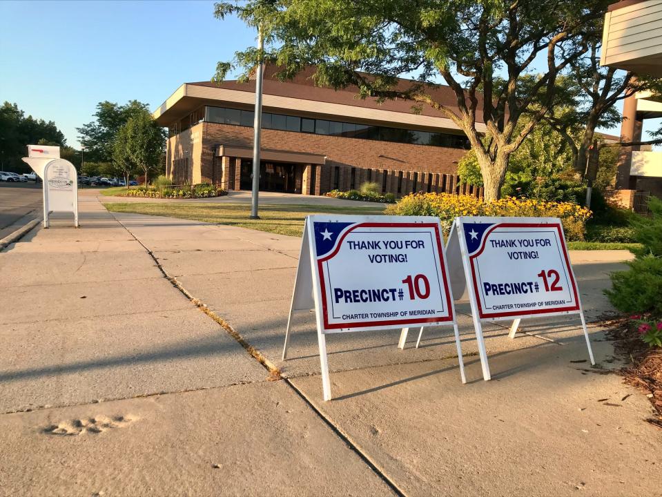 Voters leaving Meridian Township precincts 10 and 12 are greeted with thank you signs on Aug. 2, 2022 during the Michigan Primary.