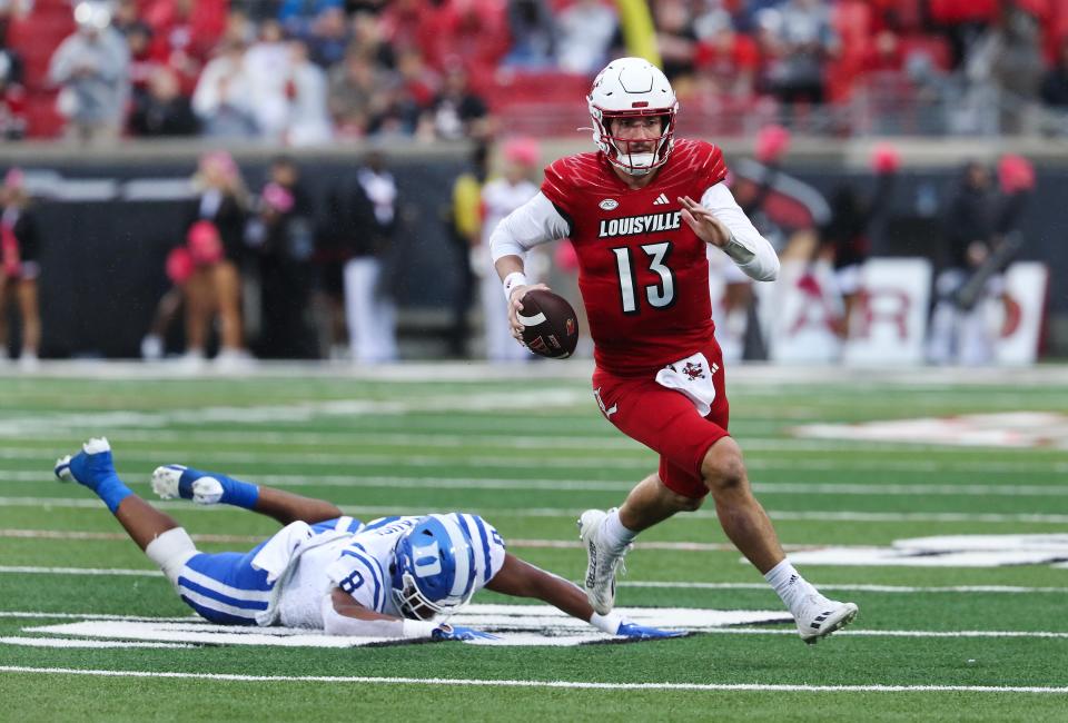 U of L QB Jack Plummer (13) scrambled and eluded Duke's Dorian Mausi (8) during Saturday's game.