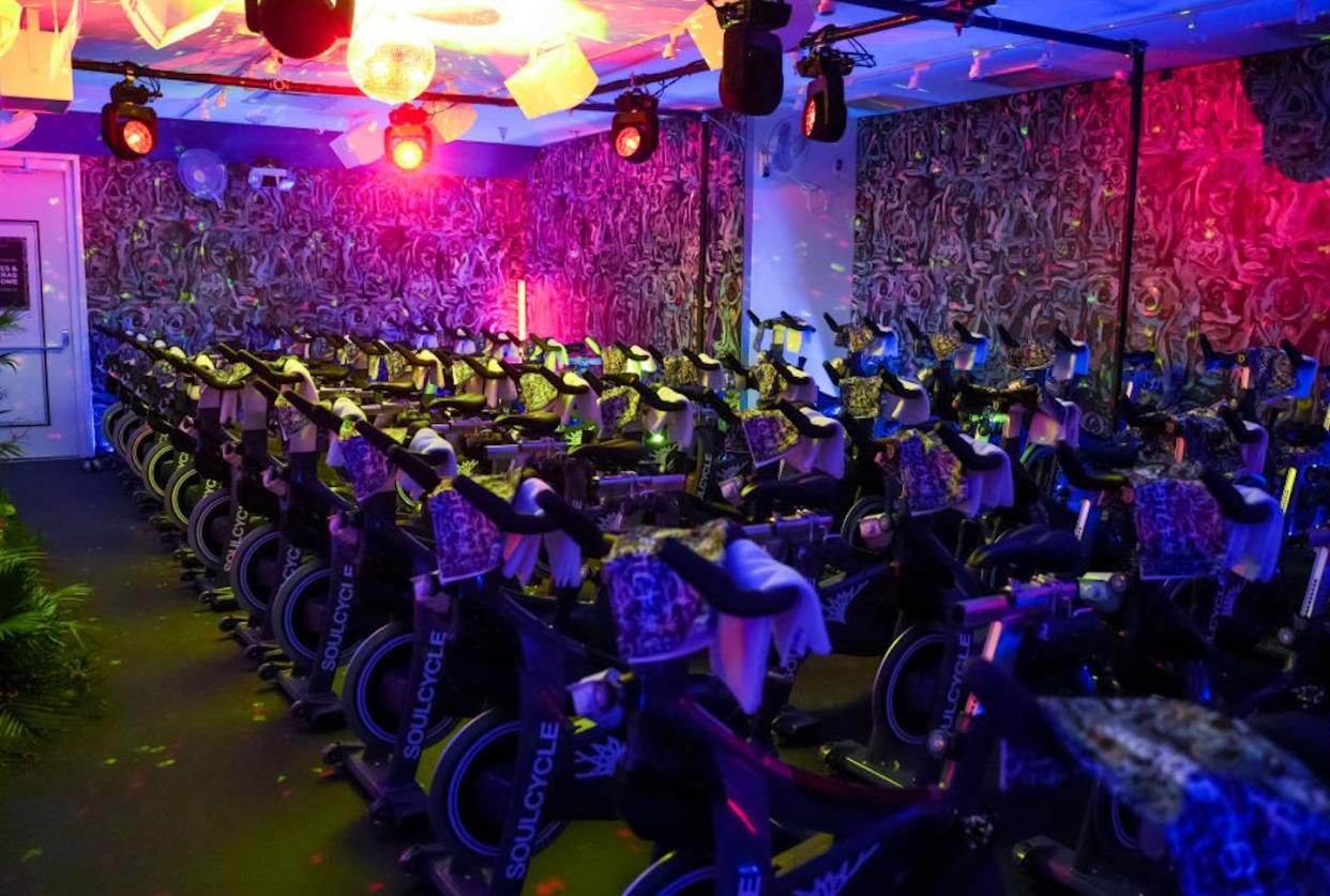 A studio set up for a SoulCycle event in New York City. <a href="https://www.gettyimages.com/detail/news-photo/atmosphere-during-bilt-x-soulcycle-live-dj-ride-feat-charly-news-photo/1435260838?phrase=soulcycle&adppopup=true" rel="nofollow noopener" target="_blank" data-ylk="slk:Sean Zanni/Patrick McMullan via Getty Images;elm:context_link;itc:0;sec:content-canvas" class="link ">Sean Zanni/Patrick McMullan via Getty Images</a>