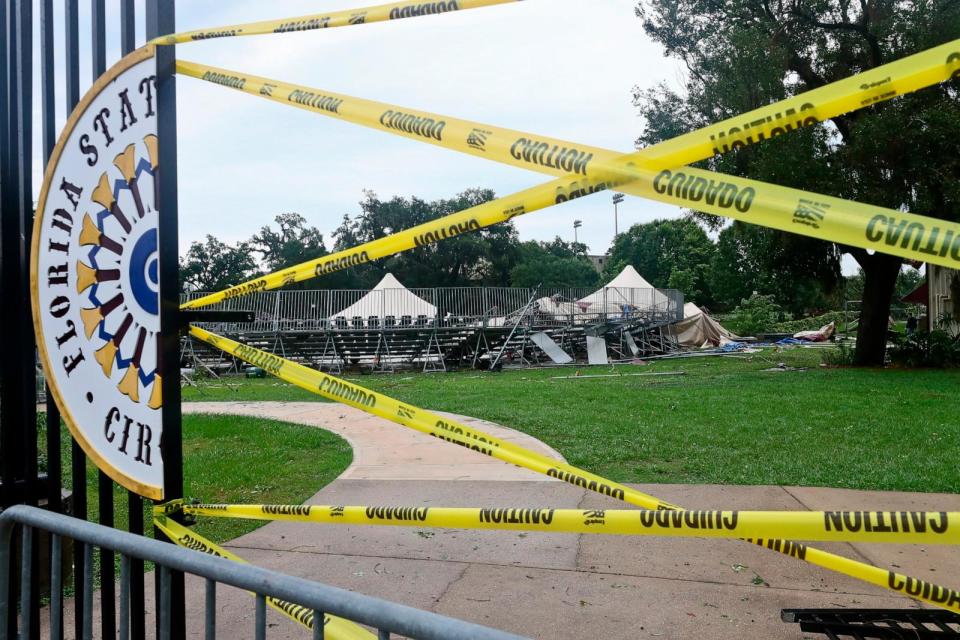 PHOTO: Caution tape blocks the path to Florida State University's Flying Circus bleachers that were damaged when the tent above them collapsed during strong weather in Tallahassee, May 10, 2024. (Phil Sears/AP)