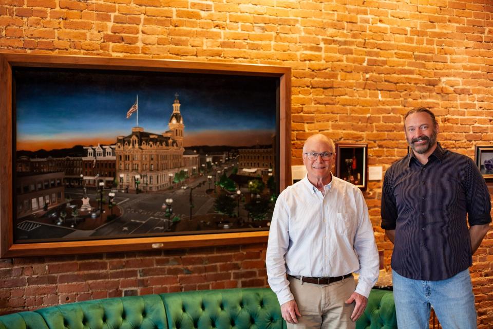 Wooster Mayor Bob Breneman and artist Michael Jackson stand by the painting Jackson did for the mayor, currently on display at Grigio Wine & Cocktail Bar in Wooster