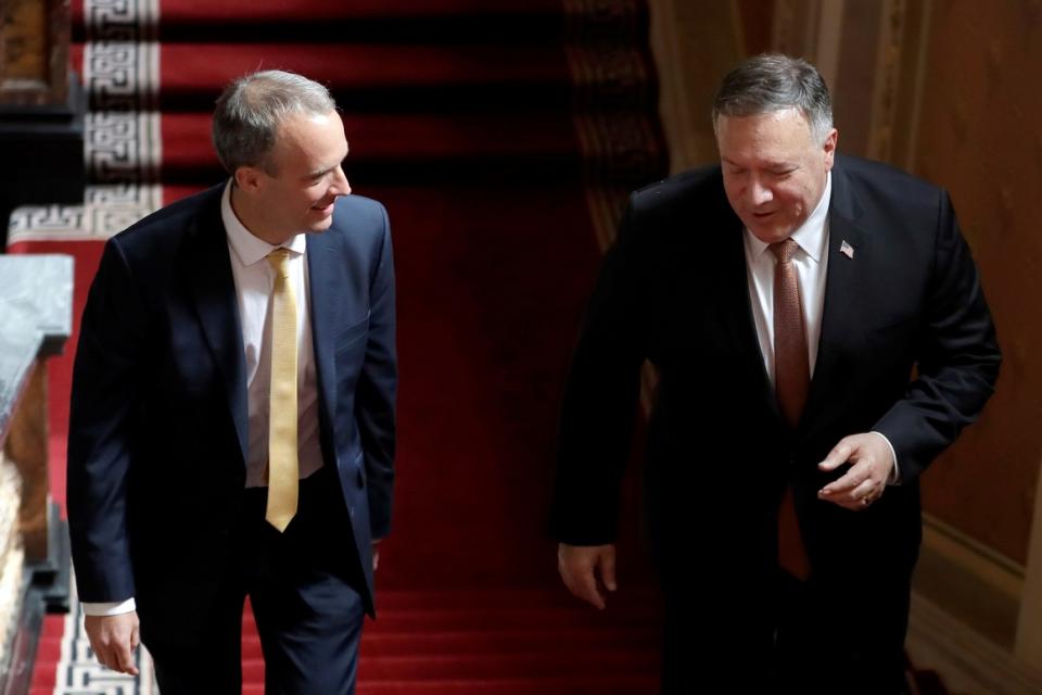 Foreign Secretary Dominic Raab of Britain and  Secretary of State Mike Pompeo (right) walk up the stairs in the Foreign Office in London on July 21, 2020. Pompeo met with Raab   just hours after Britain suspended its extradition treaty with Hong Kong and blocked arms sales to the former British territory.