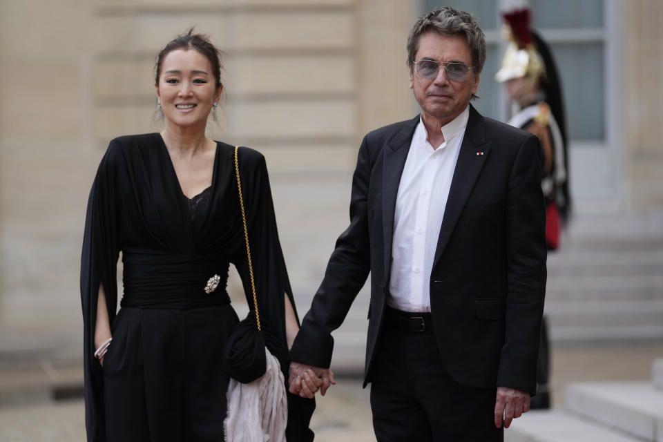 French musician Jean-Michel Jarre and Chinese actress Gong Li arrive for a state diner hosted by French President Emmanuel Macron for China's President Xi Jinping at the Elysee Palace, Monday, May 6, 2024 in Paris. (AP Photo/Thibault Camus)