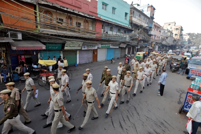 Police officers conduct a flag march in a street outside Jama Masjid, before Supreme Court's verdict on a disputed religious site claimed by both majority Hindus and Muslim in Ayodhya, in Delhi