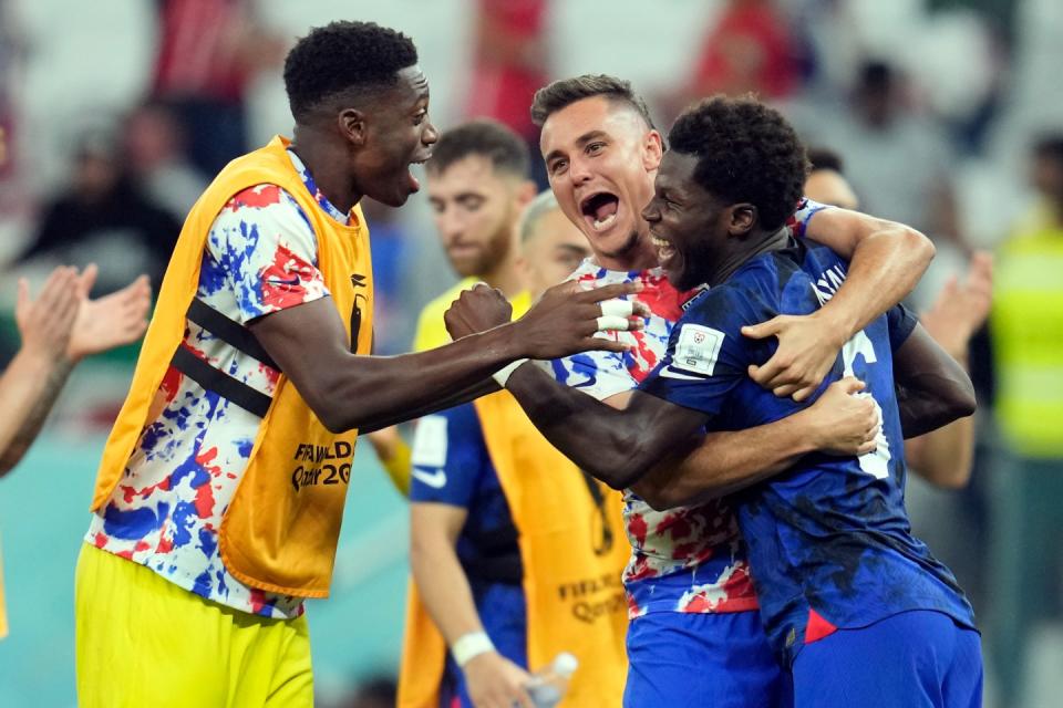 United States' Yunus Musah, right, Aaron Long, center, and United States' goalkeeper Sean Johnson celebrate after defeating Iran in the World Cup group B football match between Iran and the United States at the Al Thumama Stadium in Doha, Qatar, Tuesday, Nov. 29, 2022. (AP Photo/Ashley Landis)