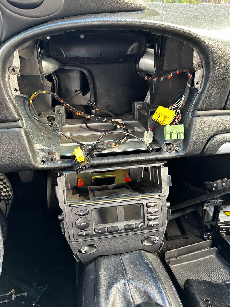 The interior center console of the 996-generation Porsche 911 disassembled.
