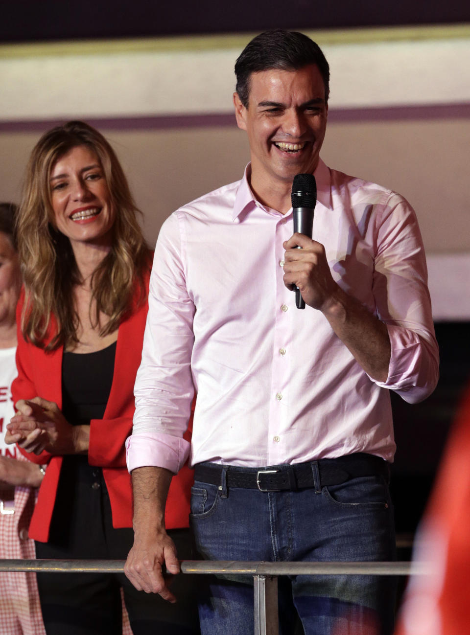 Spanish Prime Minister and Socialist Party candidate Pedro Sanchez speaks to supporters gathered at the party headquarters waiting for results of the general election in Madrid, Sunday, April 28, 2019. Spain's governing Socialists won the country's national election Sunday but will need the backing of smaller parties to stay in power, while a far-right party rode a groundswell of support to enter the lower house of parliament for the first time in four decades, provisional results showed. At left is his wife Maria Begona Gomez. (AP Photo/Andrea Comas)