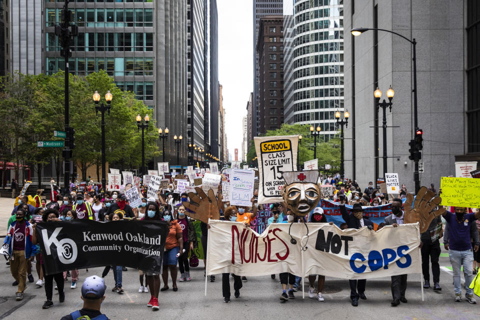 Chicago Teachers Union members and hundreds of supporters march through the Loop, Wednesday, June 24, 2020. The Chicago Teachers Union said Sunday, Jan. 24, 2021 that its members voted to defy an order to return to the classroom over concerns about COVID-19, setting up a showdown with district officials who have said such a move would amount to an illegal strike. (Ashlee Rezin Garcia/Chicago Sun-Times via AP)