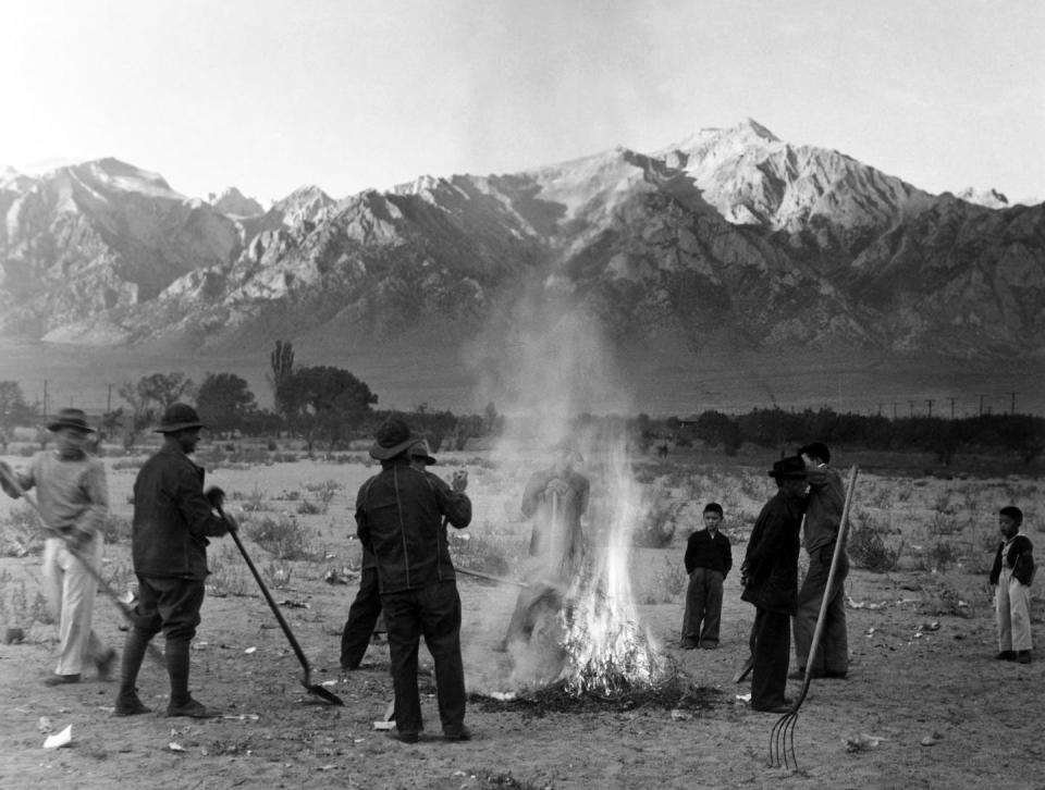 People burn leaves at the Manzanar Japanese American internment camp in California in 1943. <a href="https://media.gettyimages.com/photos/manzanar-is-most-widely-known-as-the-site-of-one-of-ten-camps-where-picture-id1354476884?s=2048x2048" rel="nofollow noopener" target="_blank" data-ylk="slk:Pictures From History/Universal Images Group via Getty Images;elm:context_link;itc:0;sec:content-canvas" class="link ">Pictures From History/Universal Images Group via Getty Images</a>