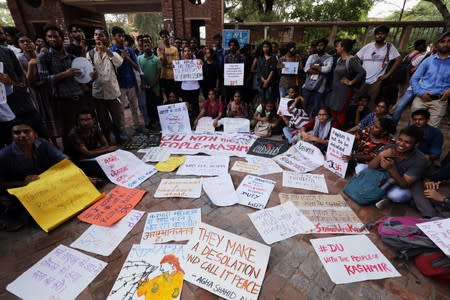 Students display placards during a protest against the scrapping of the special constitutional status for Kashmir by the government, in New Delhi