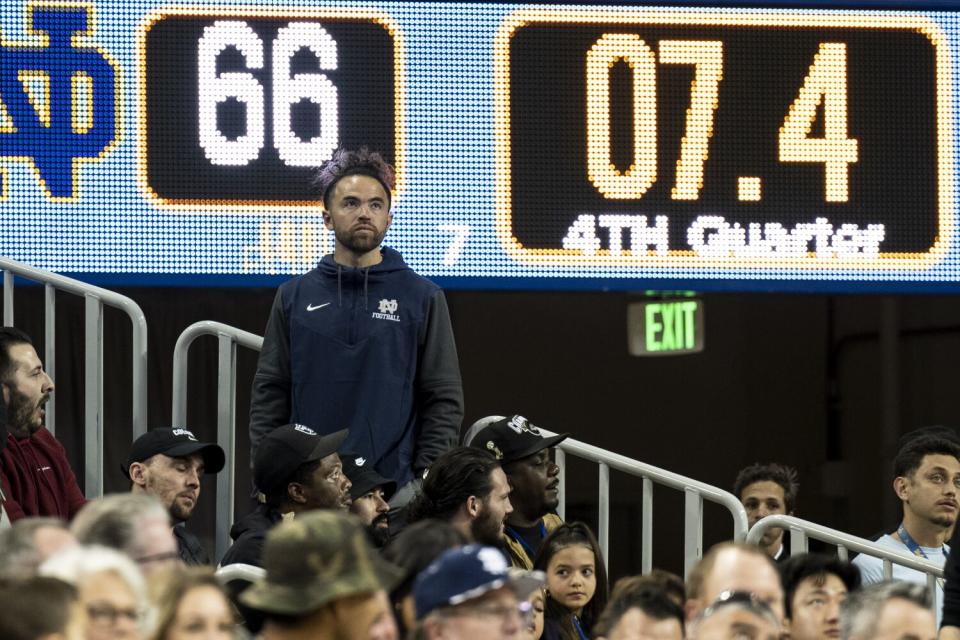 Football coach Evan Yabu watches a Notre Dame High basketball game against rival Sierra Canyon.