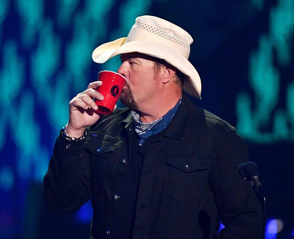Toby Keith takes a drink from his red solo cup on stage during the June 5, 2019, 2019 CMT Music Awards show at Bridgestone Arena in Nashville.