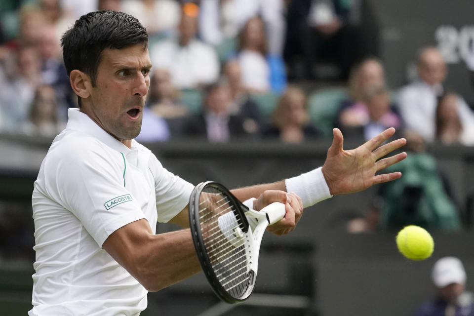 Serbia's Novak Djokovic returns the ball to Serbia's Miomir Kecmanovic in a men's singles match on day five of the Wimbledon tennis championships in London, Friday, July 1, 2022. (AP Photo/Alberto Pezzali)