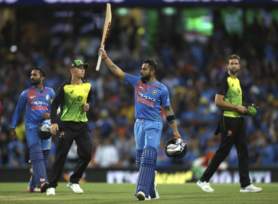 India's Virhat Kohli waves his bat to the crowd as he celebrates his team's six wicket win over Australia in their Twenty20 cricket match in Sydney, Sunday, Nov. 25, 2018. (AP Photo/Rick Rycroft)