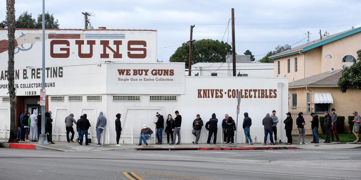 People wait in a line to enter a gun store in Culver City, Calif., Sunday, March 15, 2020.