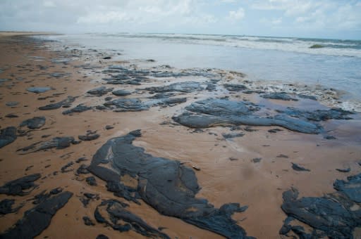 A handout picture released by the Sergipe State Environment Administration on September 25, 2019, shows oil spilled on a beach in Pirambu, Sergipe state, Brazil