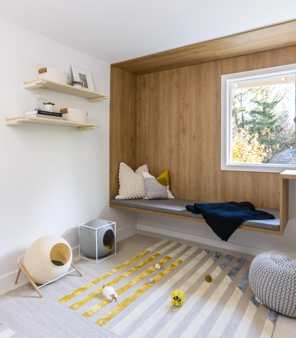 This image released by Anna Popov shows a spare room that was converted to a reading room with climbing shelves and cubbies for cats to enjoy in Redmond, Wash., designed by Anna Popov. (John Granen via AP)