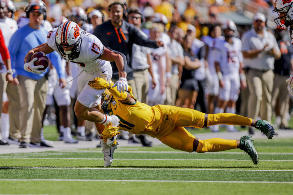 Oklahoma State wide receiver John Paul Richardson (17) is brought to the ground by Baylor defender Lorando Johnson (11) during the first half of an NCAA college football game in Waco, Texas, Saturday, Oct. 1, 2022. (AP Photo/Gareth Patterson)