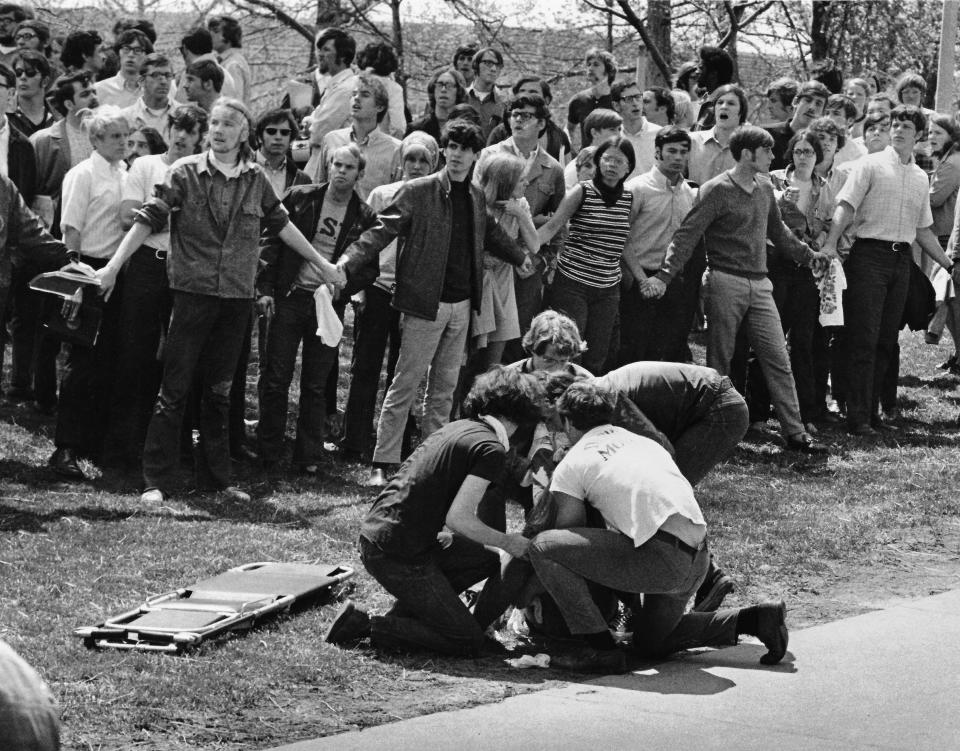 Students form a human chain to hold back the crowd and clear the way for rescue workers who are helping one of the shooting victims on May 4, 1970, at Kent State University.