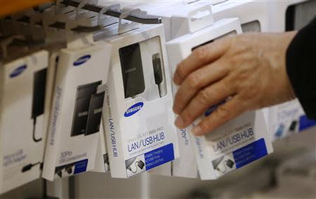 A man picks up an accessory part that is compatible with Samsung Electronics' smartphones at the company's headquarters in Seoul April 7, 2014. REUTERS/Kim Hong-ji