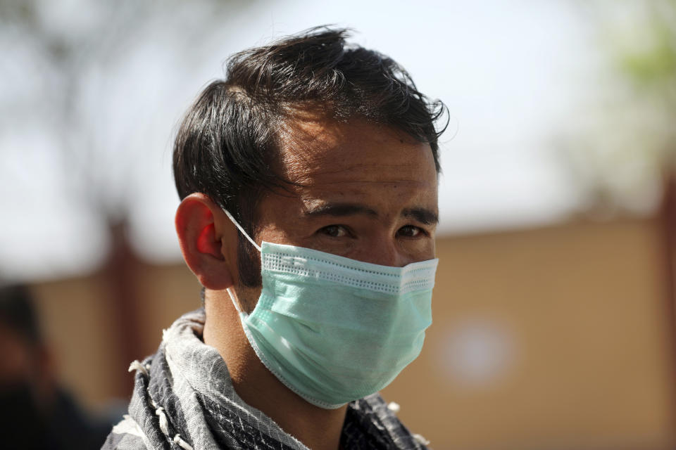 A man wearing a protective face mask to help curb the spread of the coronavirus walks in a street in Kabul, Afghanistan, Sunday, May 30, 2021. (AP Photo/Rahmat Gul)