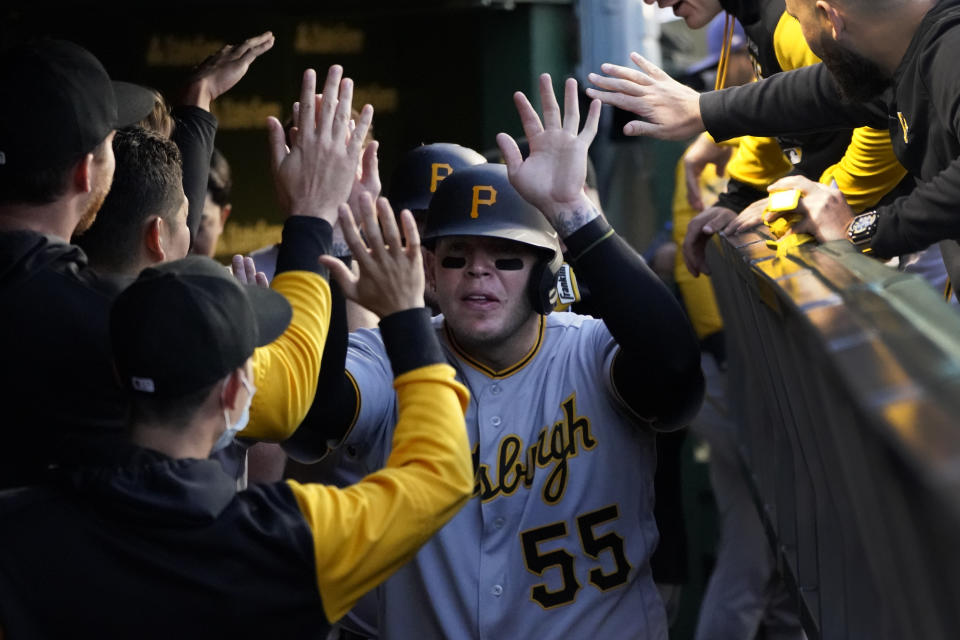 Pittsburgh Pirates' Roberto Perez celebrates in the dugout after scoring on Daniel Vogelbach's two-run home run during the third inning of the team's baseball game against the Chicago Cubs on Thursday, April 21, 2022, in Chicago. (AP Photo/Charles Rex Arbogast)