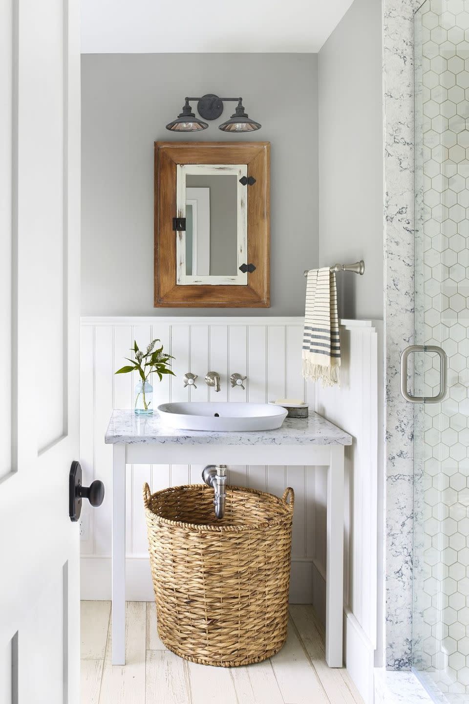 bathroom storage ideas, bathroom with a large basket under the sink