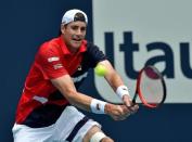 Mar 31, 2019; Miami Gardens, FL, USA; John Isner of the United States returns a shot back to Roger Federer of Switzerland during the men's finals at Miami Open Tennis Complex. Steve Mitchell-USA TODAY Sports