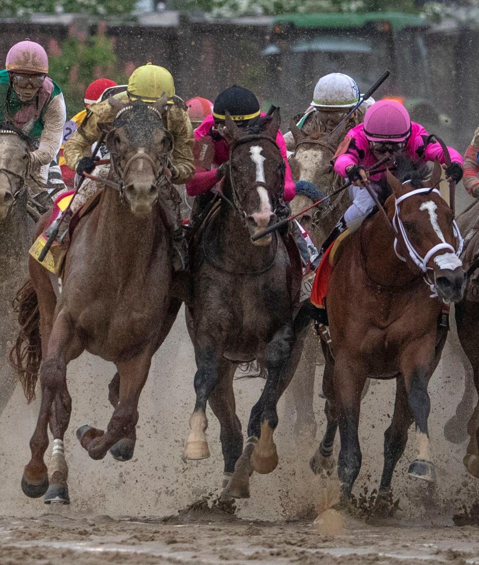 Left to right; Country House, War of Will and Maximum Security bump as they race to the head of the stretch in the Kentucky Derby. The winner Maximum Security was disqualified for causing the incident.