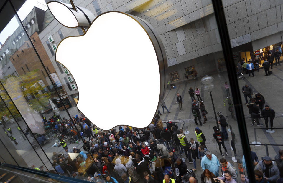 FILE-In this Sept. 25, 2015 file photo people wait in front of the Apple store in Munich, Germany. IDFA (Apple’s Identifier for Advertisers) allows Apple and all apps on the phone to track a user and combine information about online and mobile behaviour. Just like for cookies, this would require the users’ consent under EU law. Apple places these tracking codes without the knowledge or agreement of the users. noyb therefore filed two complaints against the company. (AP Photo/Matthias Schrader)