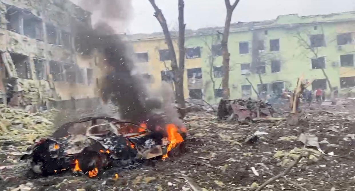 A car burns after the destruction of Mariupol children's hospital as Russia's invasion of Ukraine continues, in Mariupol, Ukraine, March 9, 2022 in this still image from a handout video obtained by Reuters. Ukraine Military/Handout via REUTERS    THIS IMAGE HAS BEEN SUPPLIED BY A THIRD PARTY.