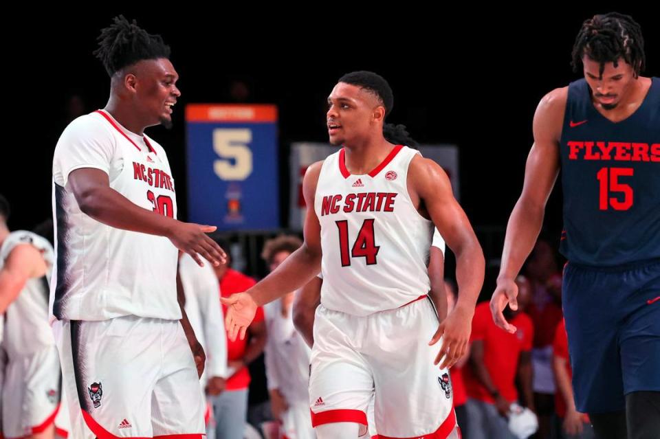 In a photo provided by Bahamas Visual Services, North Carolina DJ Burns (30) and Casey Morsell (14) celebrate as Dayton’s DaRon Holmes II (15) walks away during an NCAA college basketball game in the Battle 4 Atlantis at Paradise Island, Bahamas, Thursday, Nov. 24, 2022. (Tim Aylen/Bahamas Visual Services via AP)