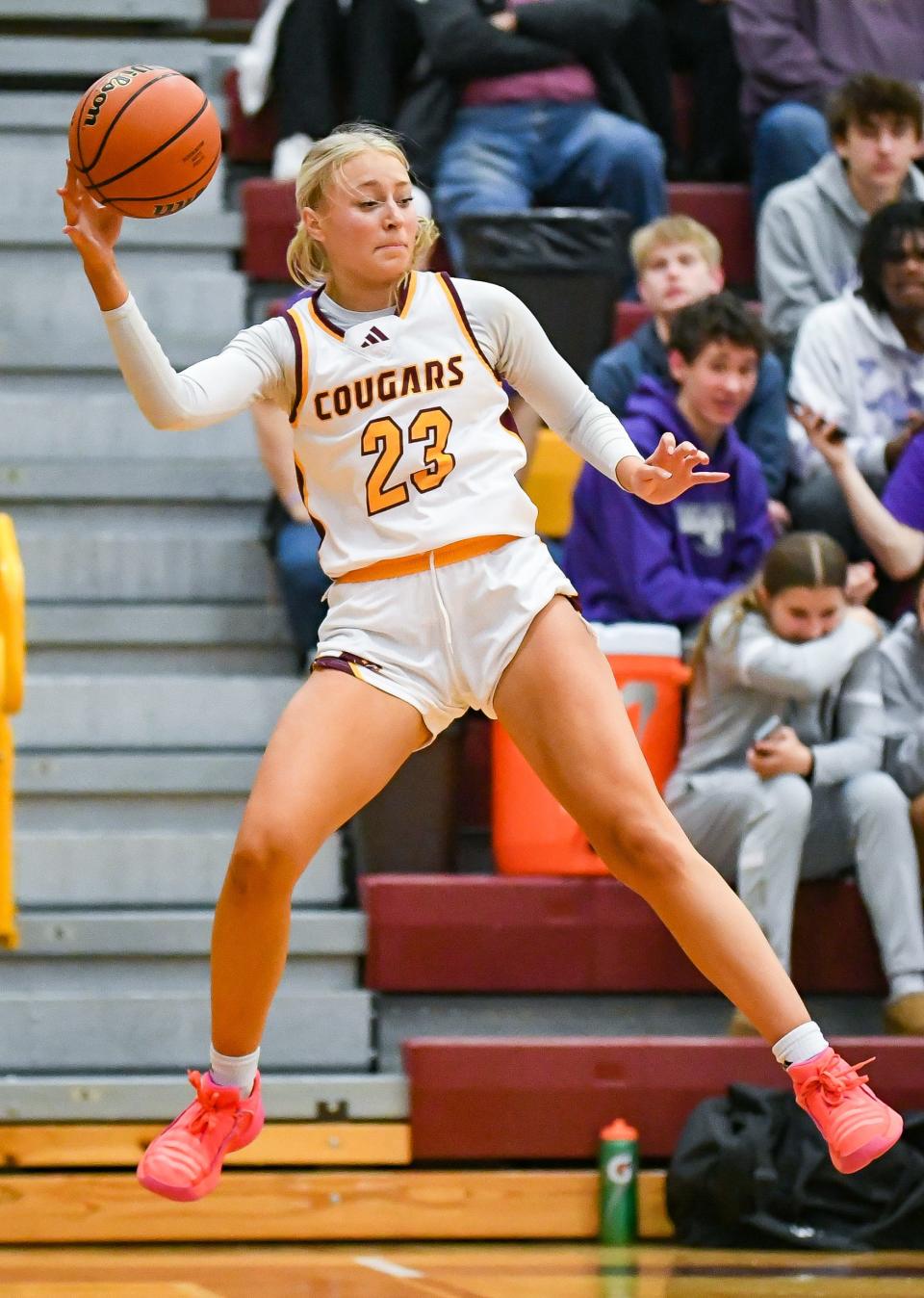 Bloomington North’s Mia Robbennolt (23) saves the ball from going out of bounds during the game against Bloomington South at North on Thursday, Dec. 14, 2023.