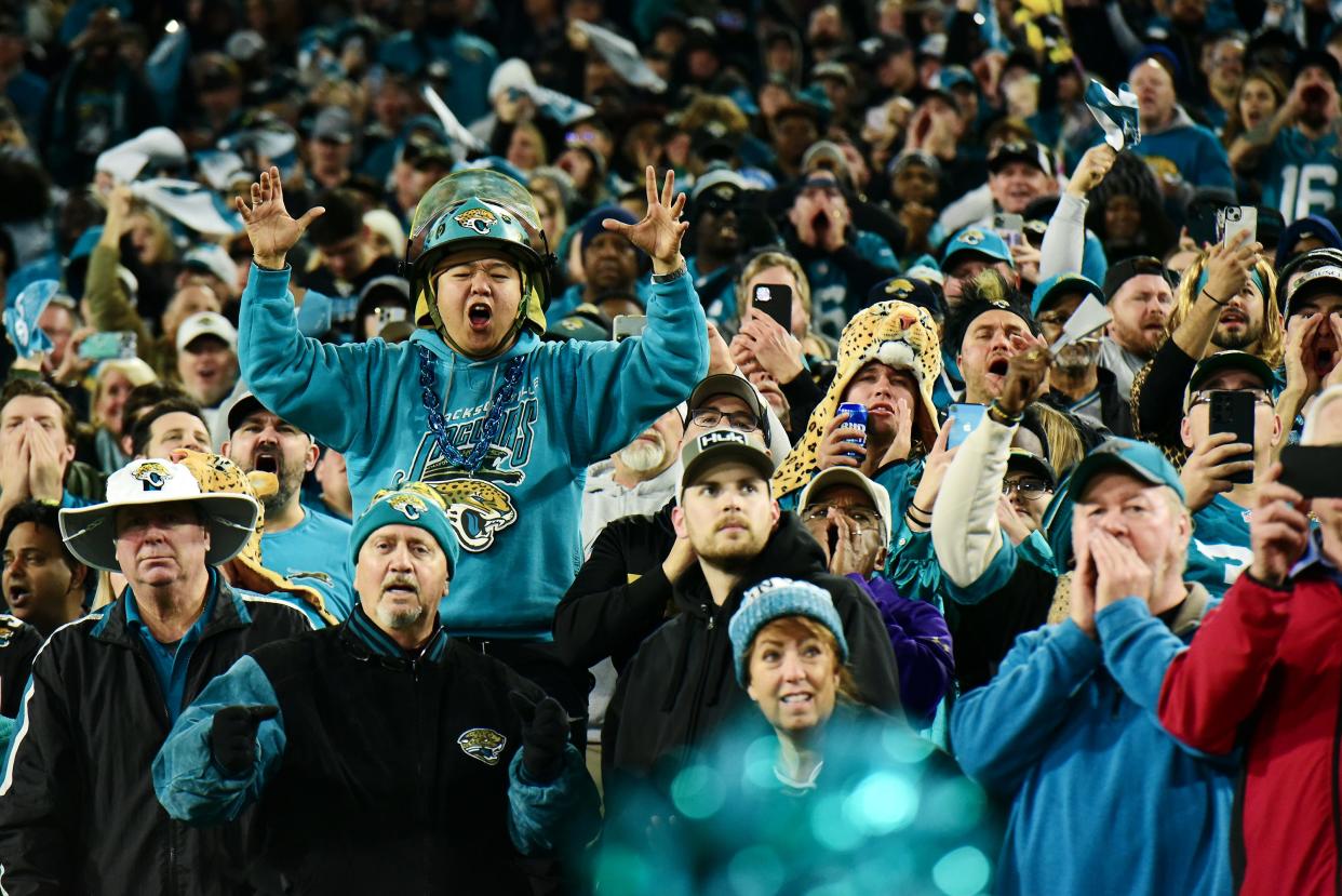 Jaguars fans celebrate last week's victory over the Tennessee Titans in the first Saturday night game in franchise history. They're under the lights on Saturday again this week in the first round of the AFC playoffs.