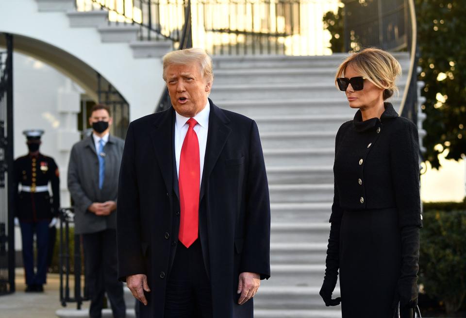 US President Donald Trump and First Lady Melania Trump talk to the press as they depart the White House in Washington, DC, on Jan. 20, 2021.