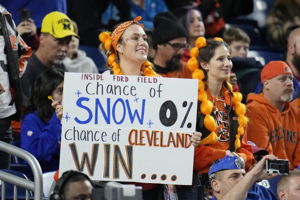 A football fan holds a sign during the first half of an NFL football game between the Buffalo Bills and the Cleveland Browns, Sunday, Nov. 20, 2022, in Detroit. (AP Photo/Paul Sancya)