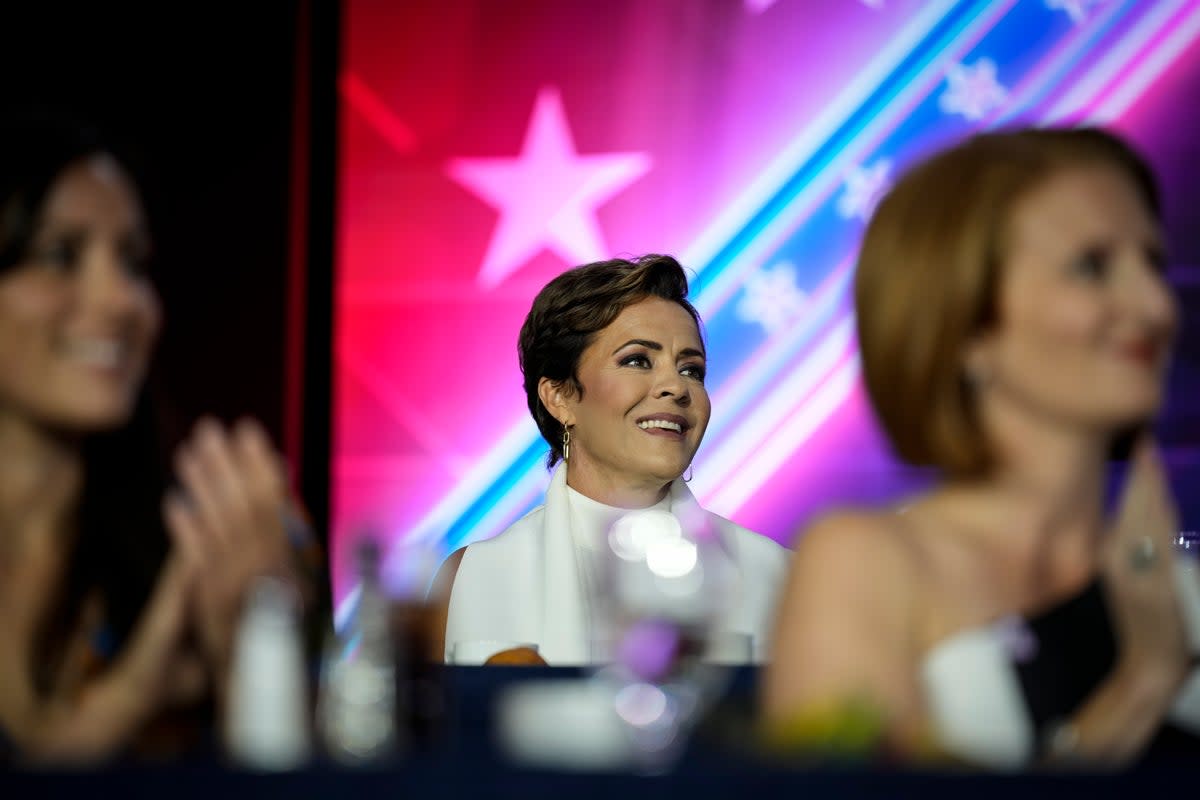 Kari Lake listens as Donald Trump speaks at the Faith and Freedom Road to Majority conference (Getty Images)