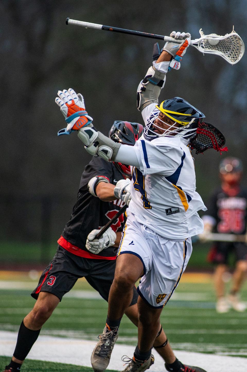 Red Hook's Matt Mulkins, left, shoves Lourdes' Alex Crysler during an April 19, 2024 boys lacrosse game.