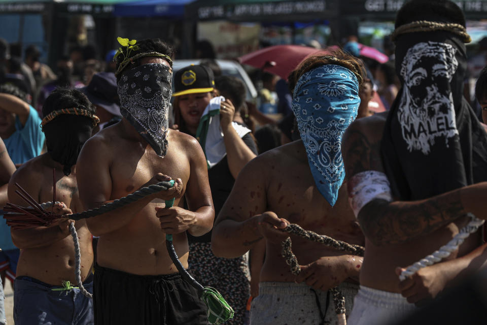 Filipino flagellants walk along San Pedro Cutud, north of Manila, Philippines, Friday, March 29, 2024, to atone for their sins during Good Friday rituals. (AP Photo/Gerard V. Carreon)