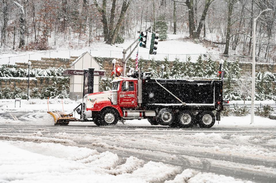 A contracted plow clears snow on Park Avenue during a storm last winter.