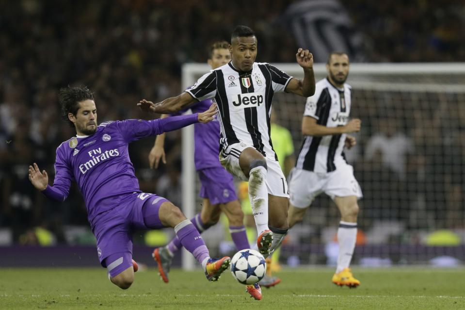 <p>Real Madrid’s Isco, left, challenges for the ball with Juventus’ Alex Sandro during the Champions League final soccer match between Juventus and Real Madrid at the Millennium Stadium in Cardiff </p>