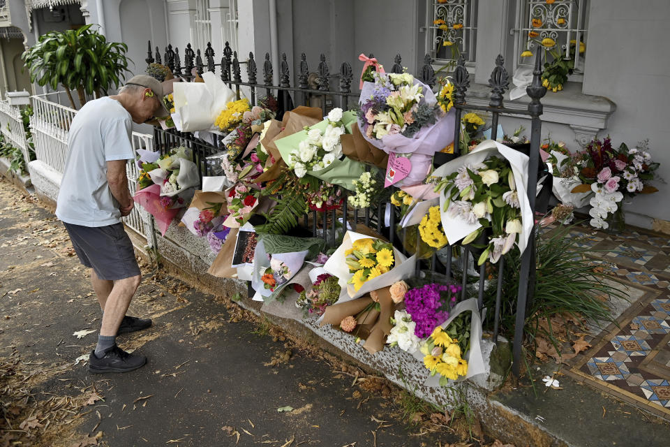 A man looks at floral tributes in Sydney, Monday, Feb. 26, 2024, at the Paddington residence of Jesse Baird, who police believe may have been murdered. Police divers were searching inland waterways on Monday for the bodies of a same-sex couple allegedly shot dead in Sydney a week earlier by a jilted police officer lover with his service pistol. (Bianca De Marchi/AAP Image via AP)