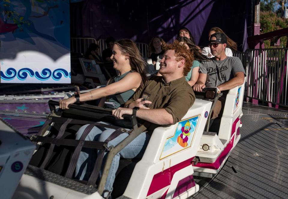 Tribune reporters John Lynch and Chloe Jones ride the Himalaya at the Mid-State Fair carnival on July 20, 2023.