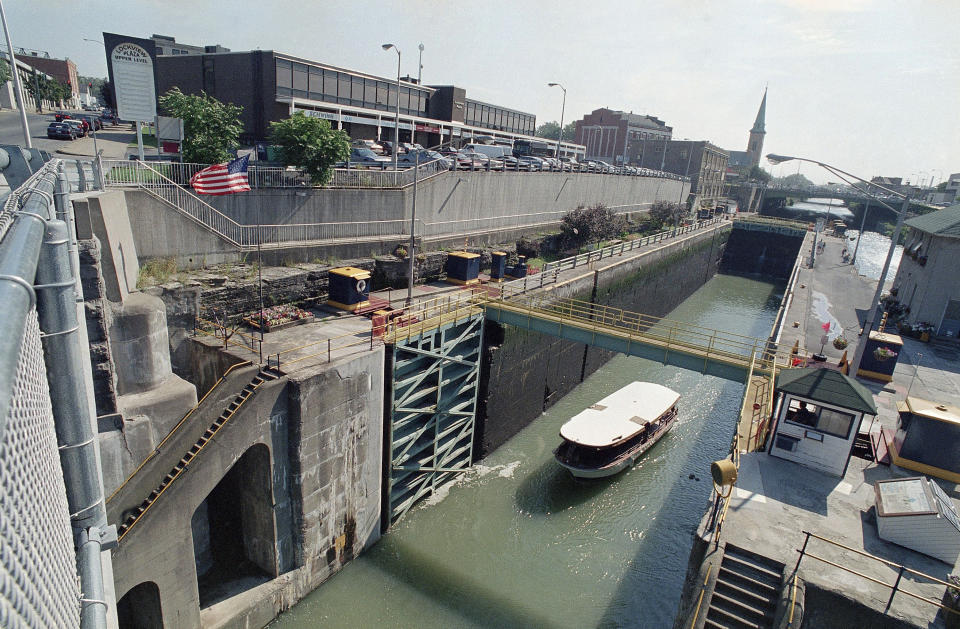 FILE - A boat moves through the double lock system on the Erie Canal in downtown Lockport, N.Y., Aug. 24, 1993. A boat carrying 36 people capsized Monday, June 12, 2023, during a tour of an underground cavern system built to carry water from the Erie Canal beneath the western New York city of Lockport, police said. (AP Photo/Bill Sikes, File)